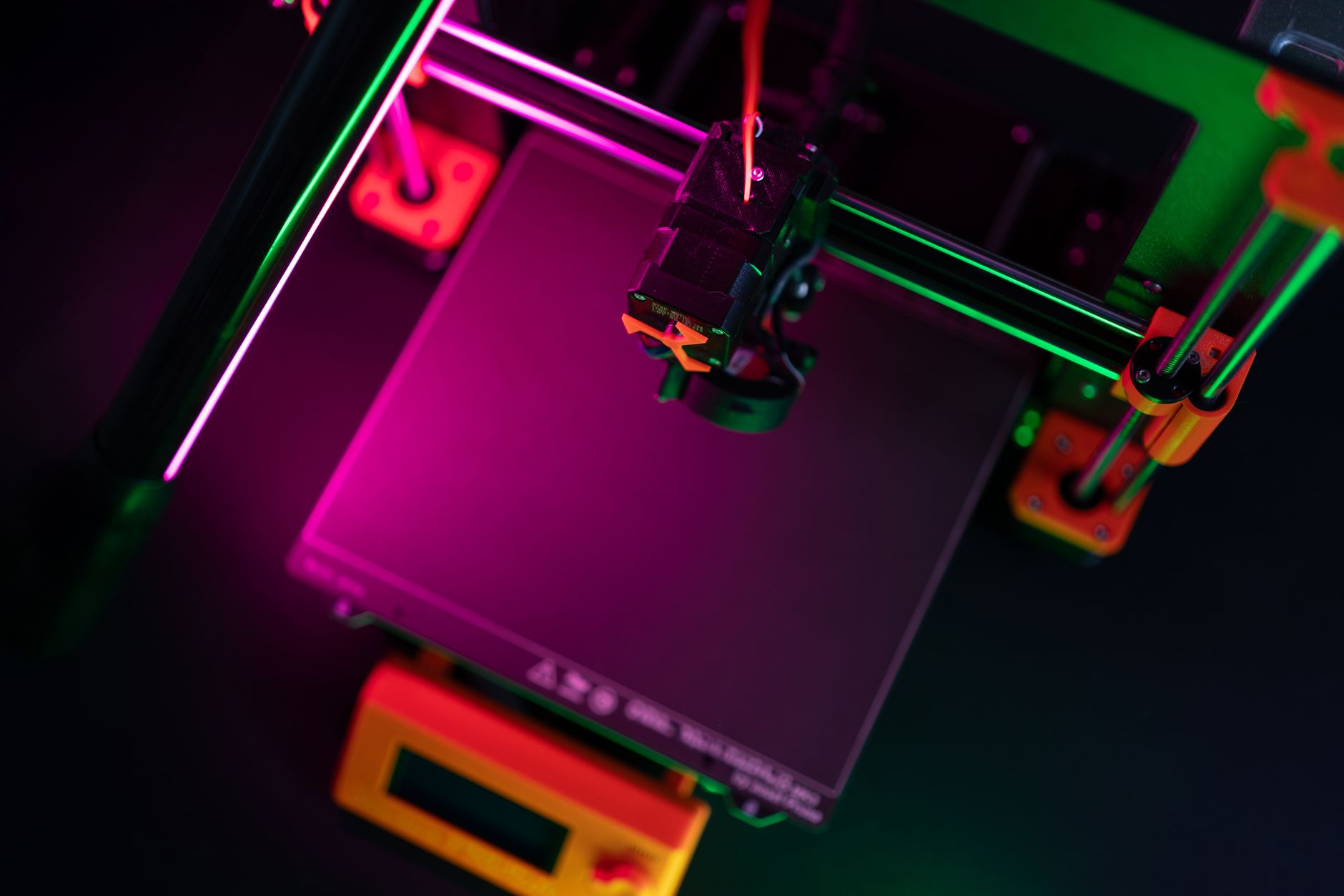 Detailed view of a 3D printer nozzle during the printing process, showcasing advanced technology.