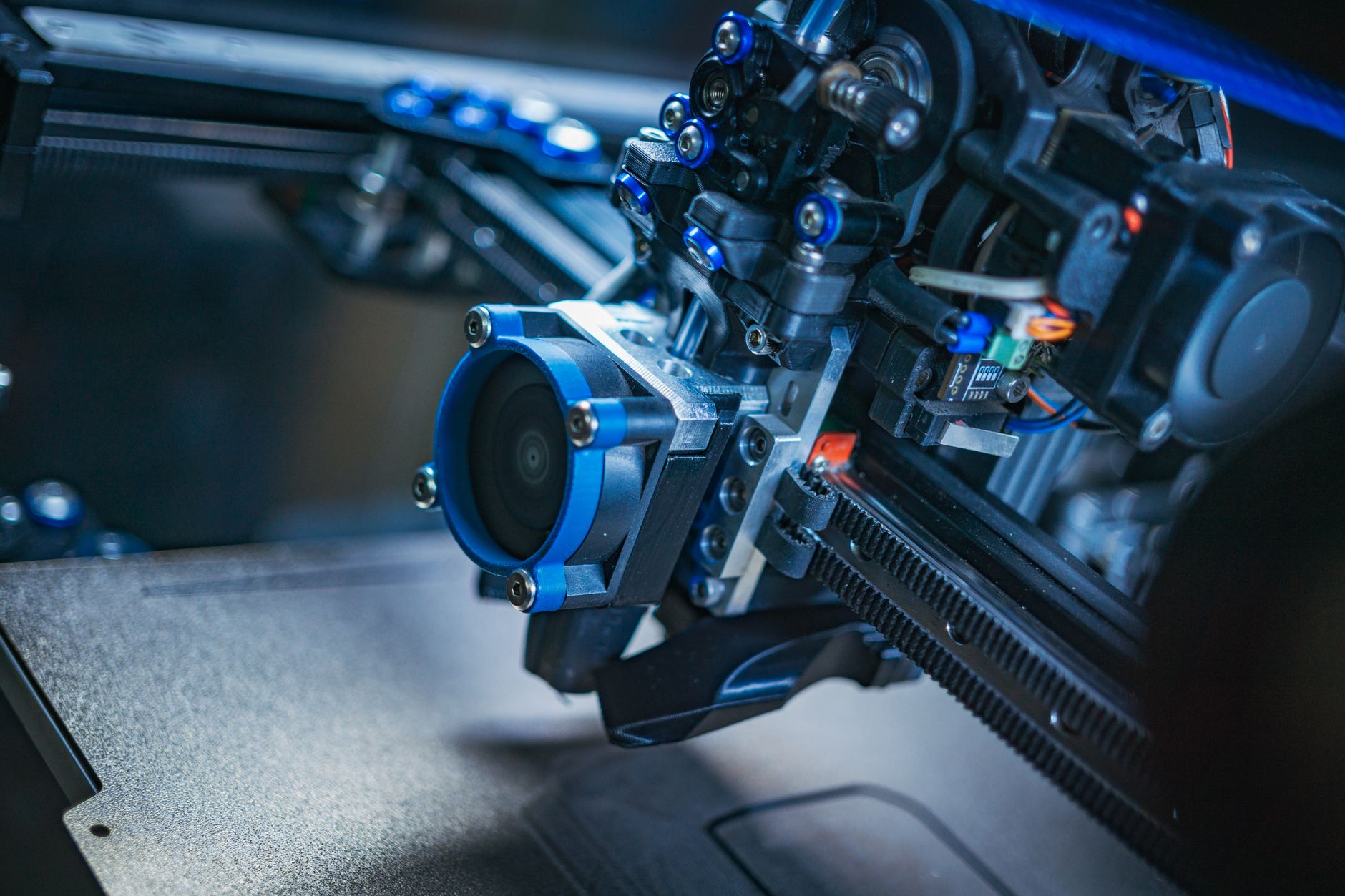 Close up of dual nozzle 3D printer extruder printing two colors