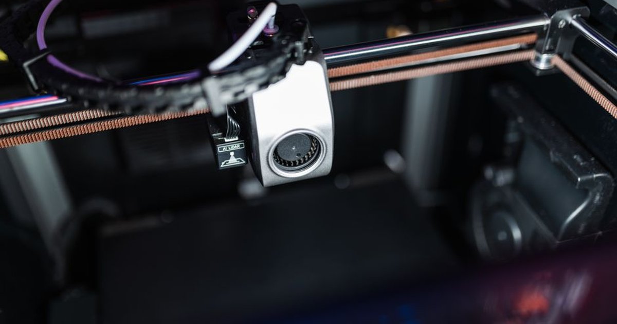 Detailed image showcasing the intricate components of a high-tech 3D printer in action.