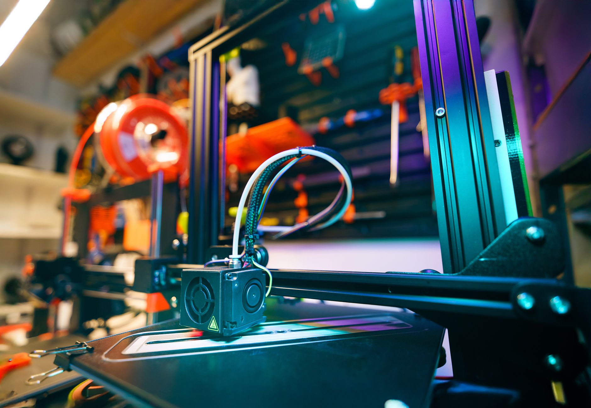 A close-up shot of a modern 3D printer operating in an industrial setting.