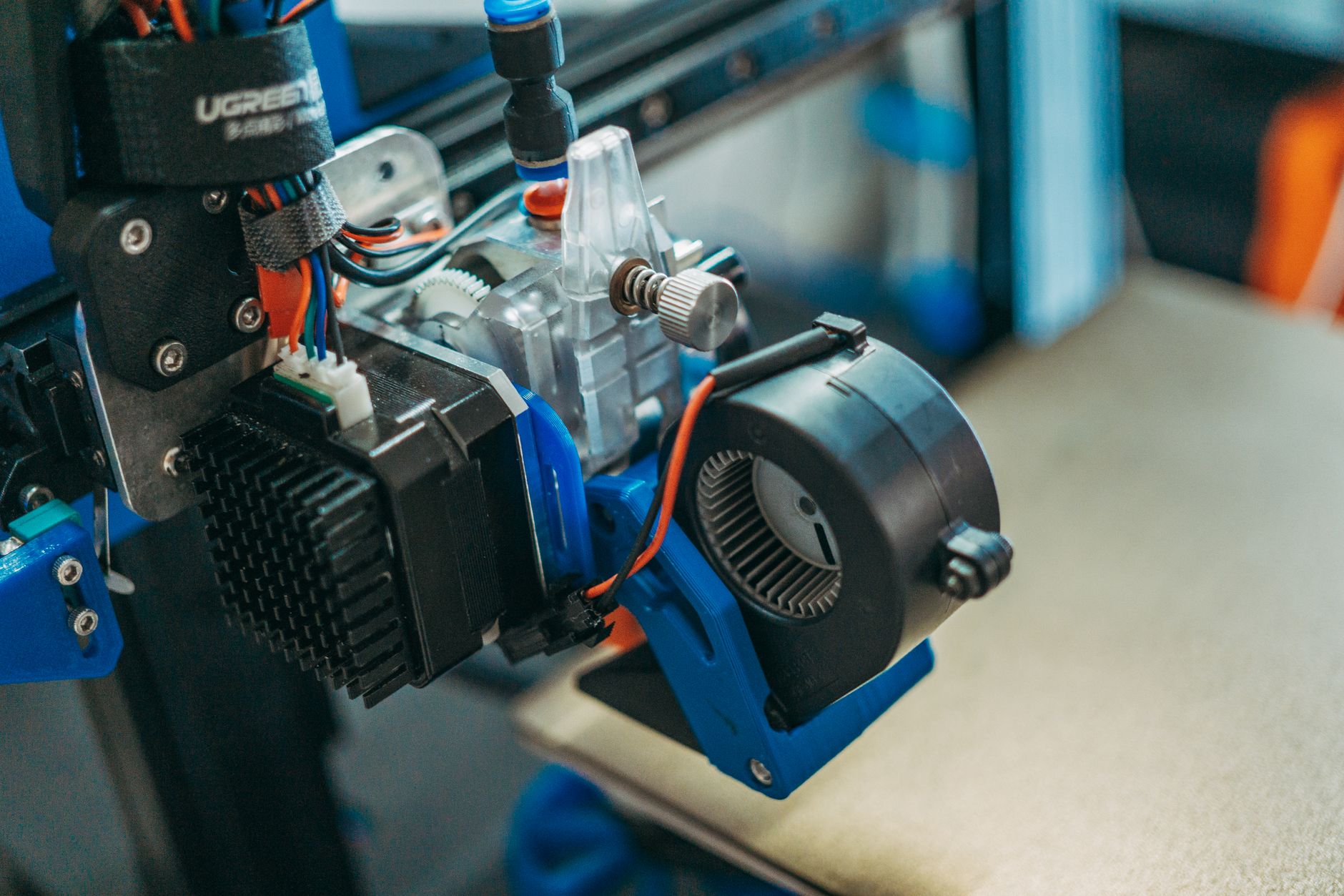 Detailed close-up view of a modern 3D printer in operation, focusing on the printhead.