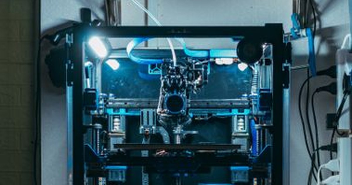 A high-tech 3D printer operating in an industrial workshop, showcasing modern technology.