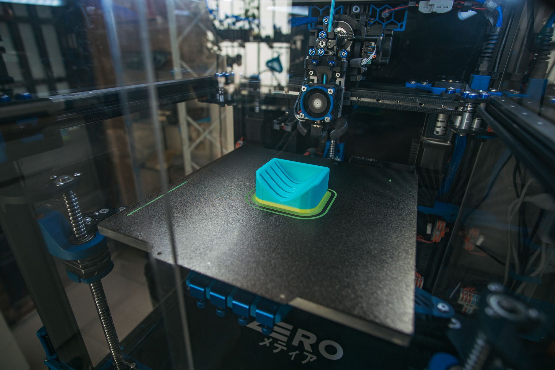 Creality K1C enclosed 3D printer printing a white model