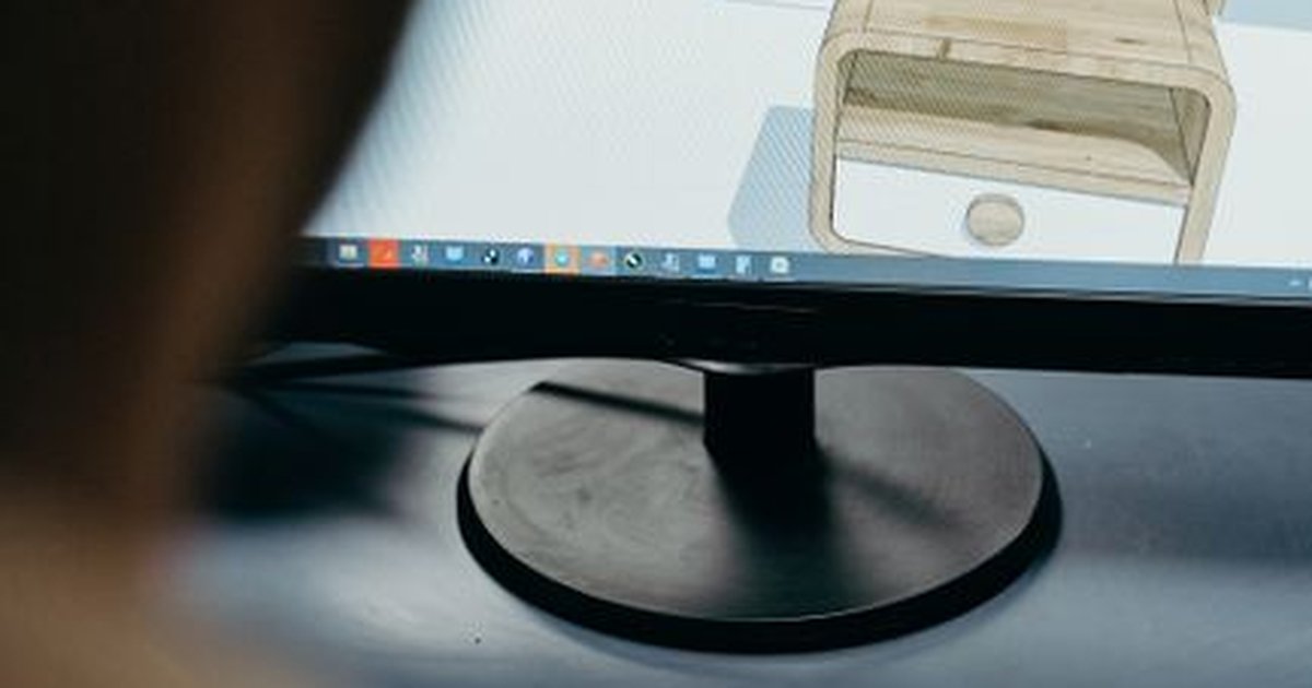 Close-up of digital furniture design on a computer monitor in an office setting.