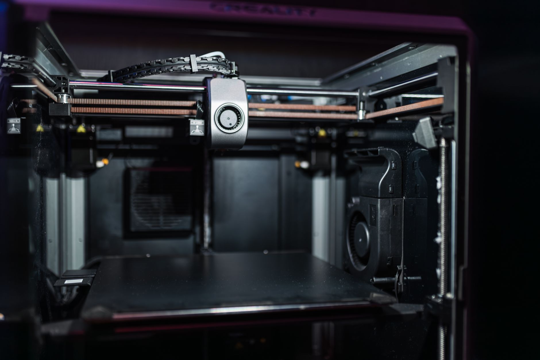 Enclosed metal 3D printer printing a steel part from bound metal filament