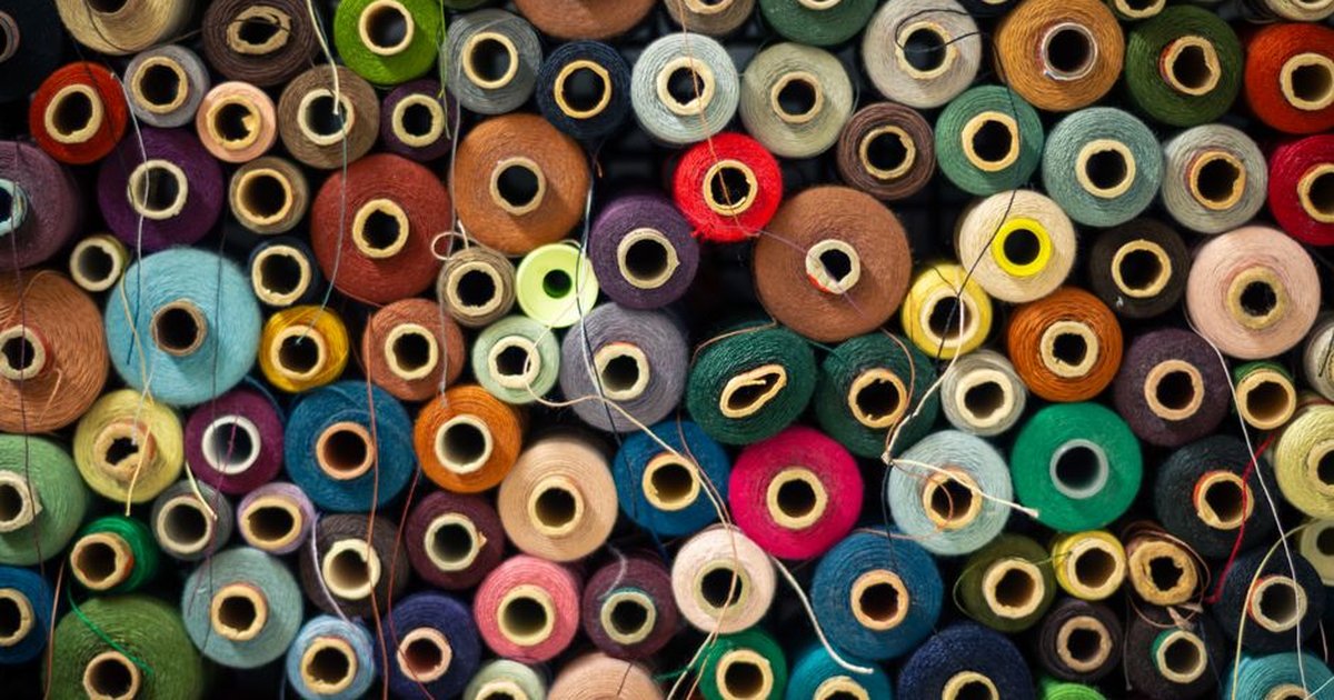 Vibrant collection of thread spools creating a colorful and artistic display.